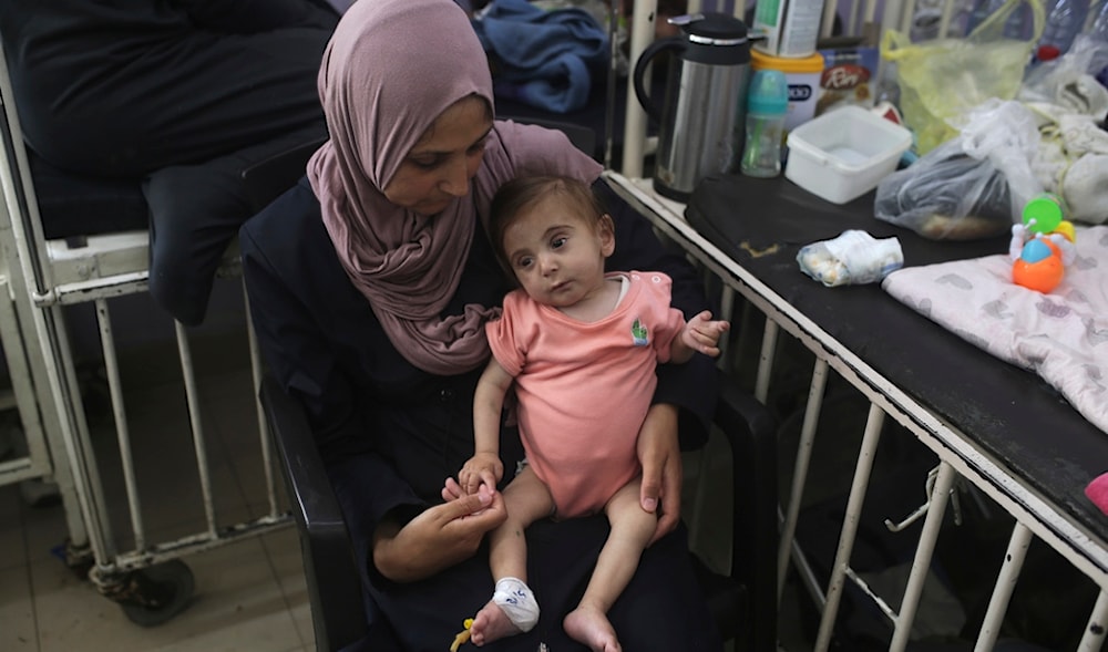 Amira Al-Jojo holds her son Yousef Al-Jojo, 10 months old, who suffers from malnutrition, at Al-Aqsa Martyrs Hospital, where he is undergoing treatment, in Deir al-Balah in the central Gaza Strip on Saturday, June 1, 2024. (AP)