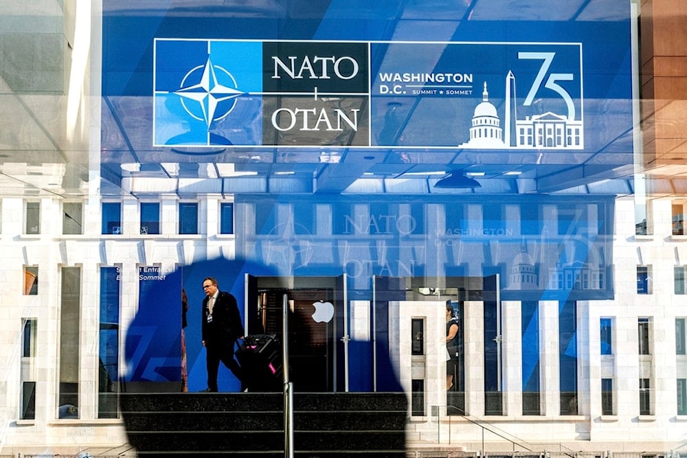 A NATO summit attendee walks through the Walter E. Washington Convention Center in Washington, on Tuesday, July 9, 2024. (AP Photo/Noah Berger)