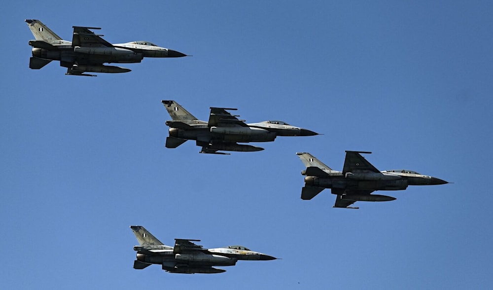 Hellenic Air Force F-16 fighter jets fly during a military parade to mark National 