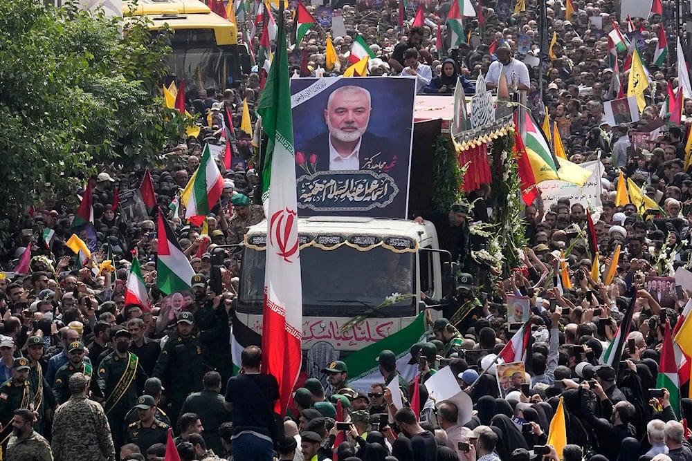 Iranians follow a truck, center, carrying the coffins of Hamas leader Ismail Haniyeh and his bodyguard who were killed in an Israeli assassination, during their funeral ceremony at Enqelab-e-Eslami Sq. in Tehran, Iran, Thursday, August 1, 2024 (AP)