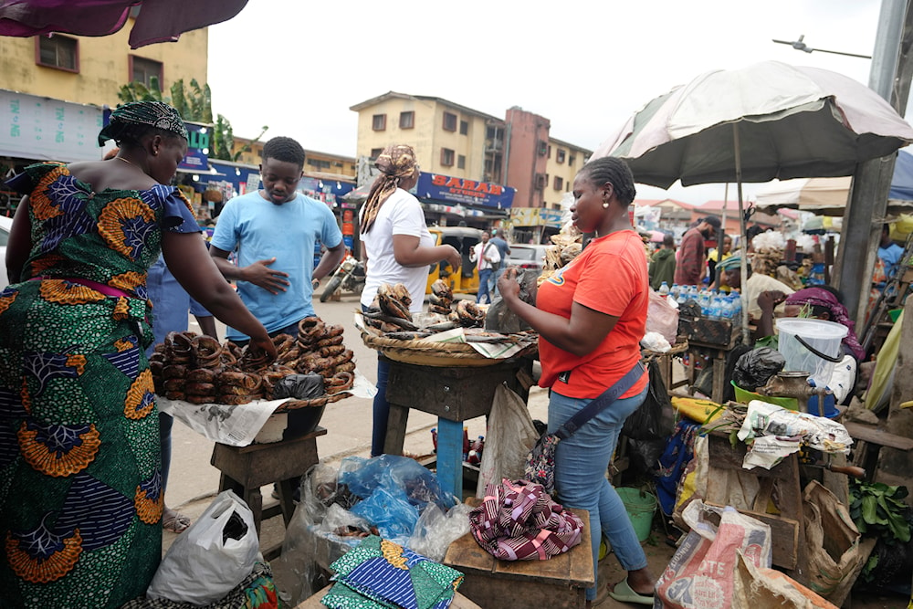 People buy food at a market in Lagos, Nigeria, on Wednesday, July. 31, 2024 (AP(