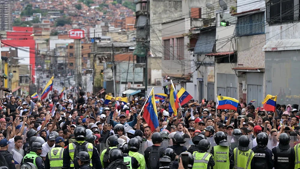 Opponents of Venezuelan President Nicolás Maduro's government protest in front of national police in the Catia neighborhood of Caracas yesterday. (Yuri Cortez/AFP via Getty Images)