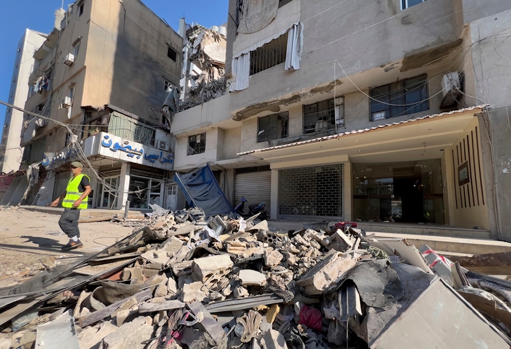 A municipality worker passes by debris of damaged buildings that were hit by an Israeli occupation airstrike on Tuesday evening in the southern suburbs of Beirut, Lebanon, Wednesday, July 31, 2024. (AP)