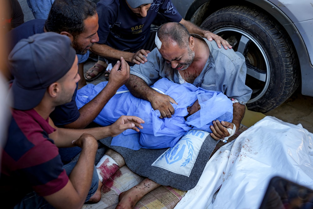 A Palestinian man mourns for a relative killed in the Israeli bombardment of the Gaza Strip, at a hospital in Deir al-Balah, on August 10, 2024. (AP)