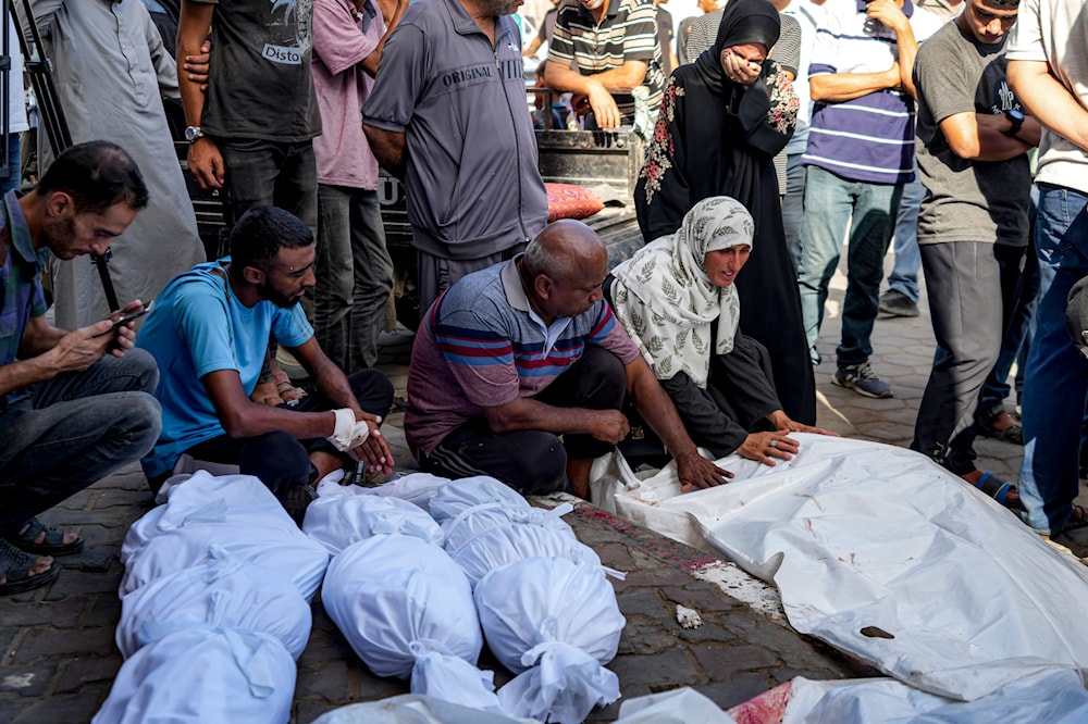 Palestinians mourn for relatives killed in the Israeli bombardment of the Gaza Strip, at a hospital in Deir al-Balah, on August. 10, 2024. 