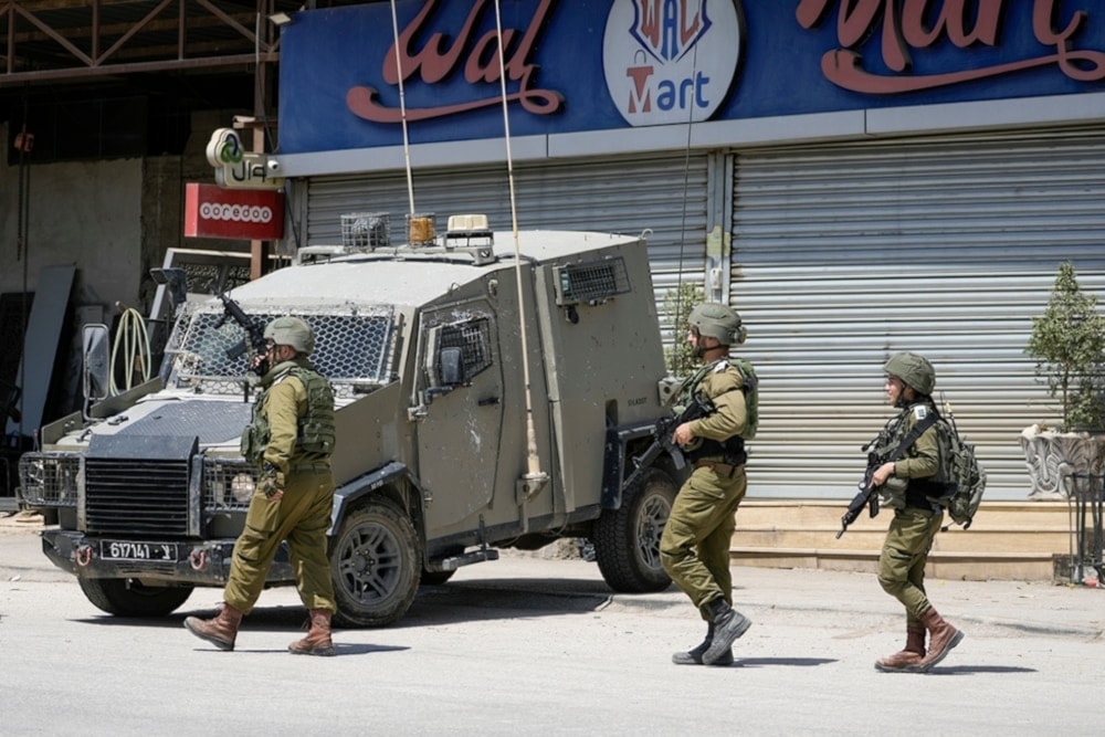 Israeli occupation forces walk back to their vehicles in the Palestinians al-Fara’a refugee camp in the occupied West Bank following an IOF military raid, on Monday, June 1,2024. (AP)