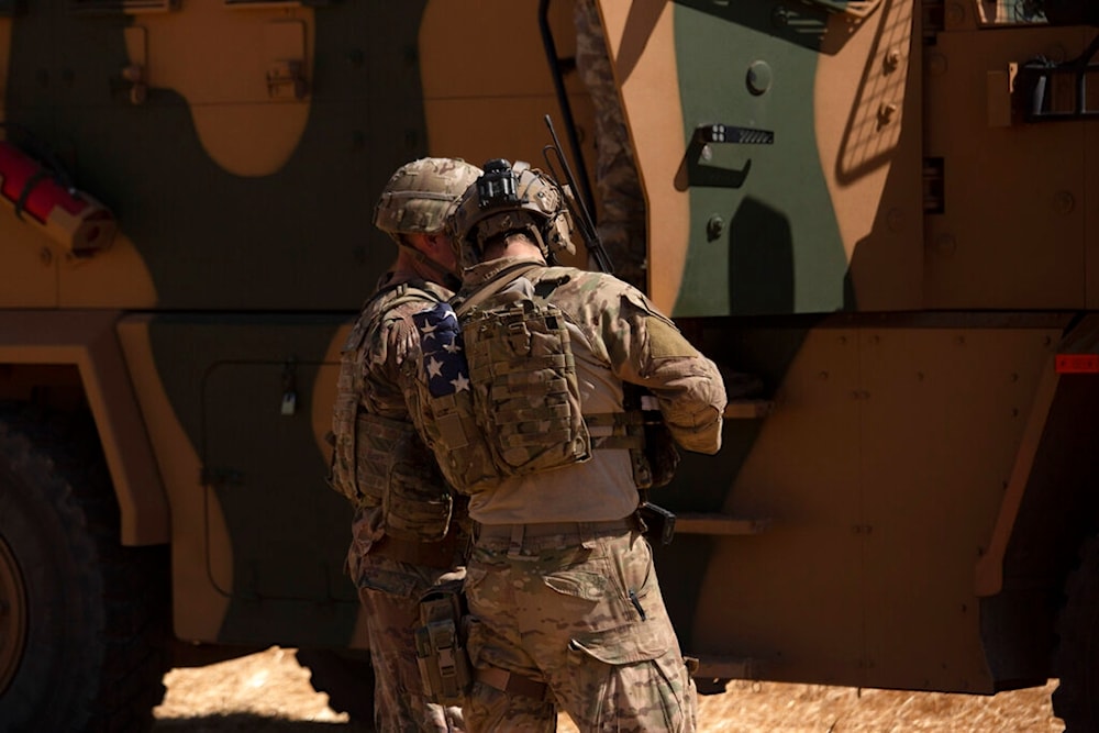 In this Sept. 8, 2019, photo, U.S. soldiers stand near a Turkish armored vehicle on the Syrian side of the border with Turkey near Tal Abyad, Syria. (AP)