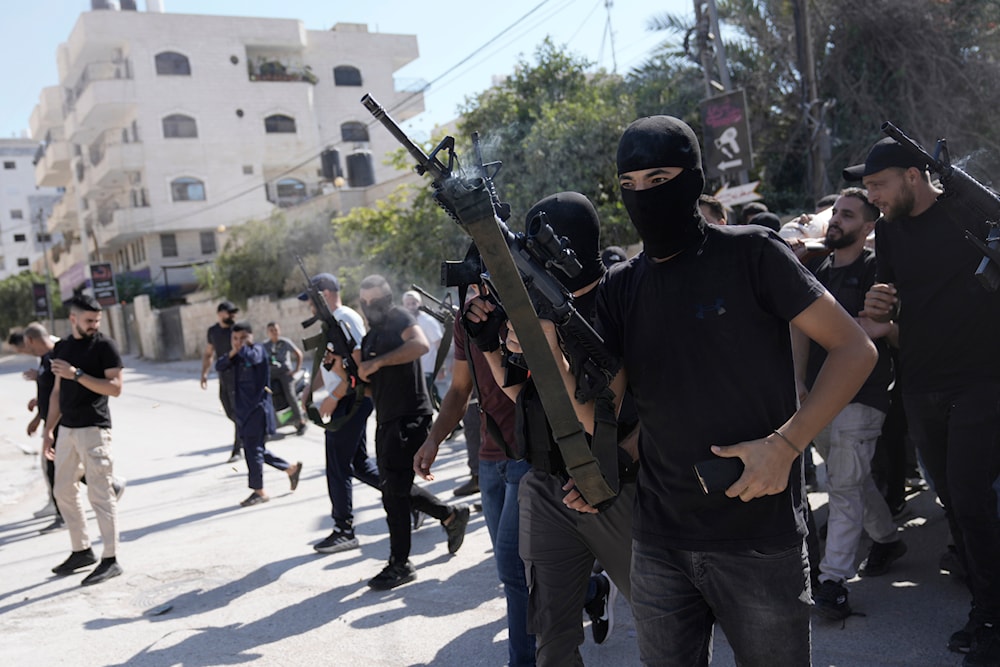 Gunmen attend the funeral of five Palestinians killed by an Israeli strike on a vehicle in the West Bank city of Jenin, Tuesday, August 6, 2024 (AP)