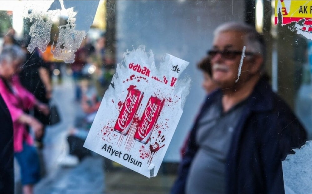 Stickers reading ‘Baby blood in your drink!’ are being used to protest against Coca-Cola, 2023. (AFP)