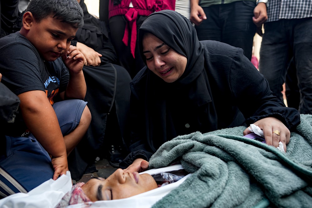 Palestinians mourn a relative killed in the Israeli bombardment of the Gaza Strip, at a hospital in Deir al-Balah, on August 4, 2024. (AP)