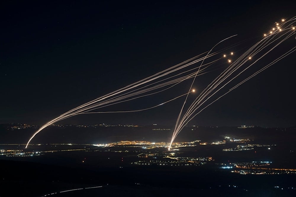 The Israeli Iron Dome air defense system fires to intercept an attack from Lebanon over the Galilee region as seen from the Israeli-occupied Syrian Golan Heights, Sunday, Aug. 4, 2024. (AP)