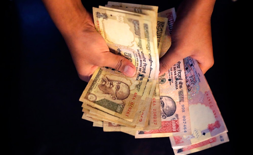 An Indian counts currency notes of 1000 and 500 denomination in New Delhi, India, Tuesday, Nov. 8, 2016. (AP)