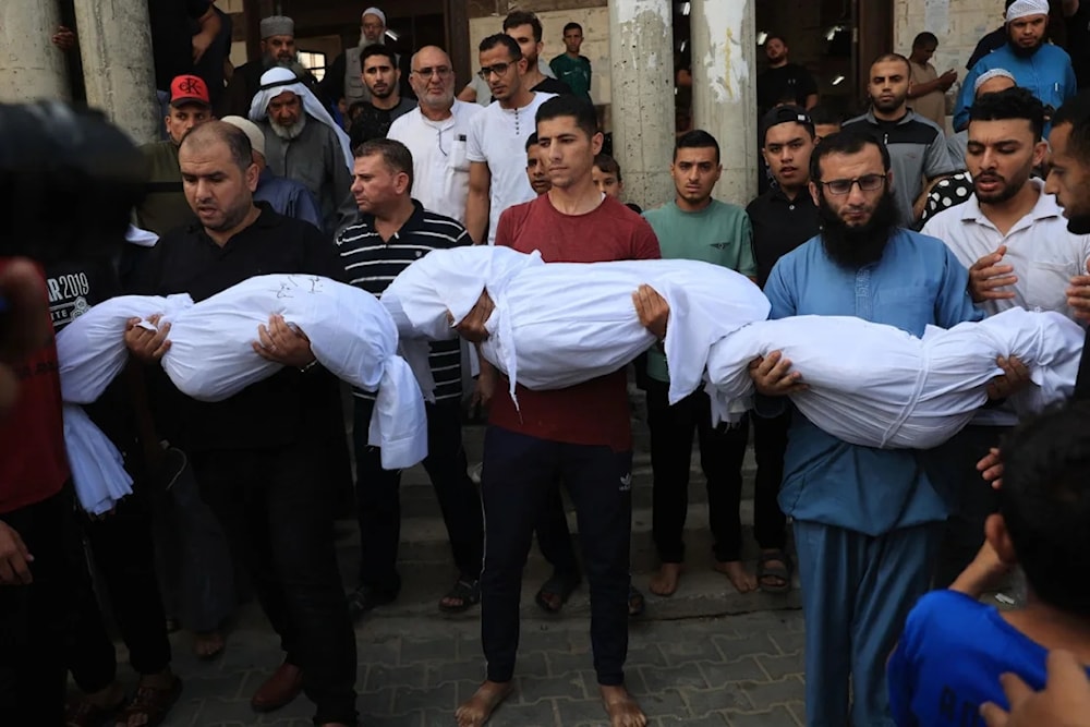 Relatives carry the bodies of children from the Abu Quta family who were killed in Israeli strikes on a residential home in Palestinian city of Rafah in the southern Gaza Strip, during their funeral on October 8, 2023. (AFP/Getty Images)