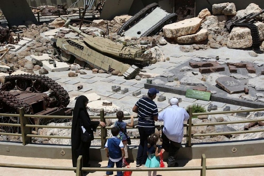 Visitors look at tanks left behind in Lebanon by Israeli forces as they visit the 'Tourist Landmark of the Resistance' war museum in Mlita (aka Mleeta) in southern Lebanon on July 12, 2016 (AFP)