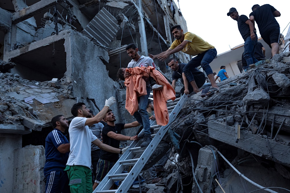 Palestinians rescue a young girl from the rubble of a destroyed residential building following an Israeli airstrike on Gaza, October 10,2023. (AP)