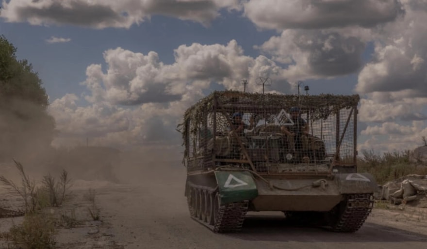 Ukrainian servicemen drive an armored military vehicle past destroyed border crossing point with Russia, in the Sumy region, on August 14, 2024. (AFP)