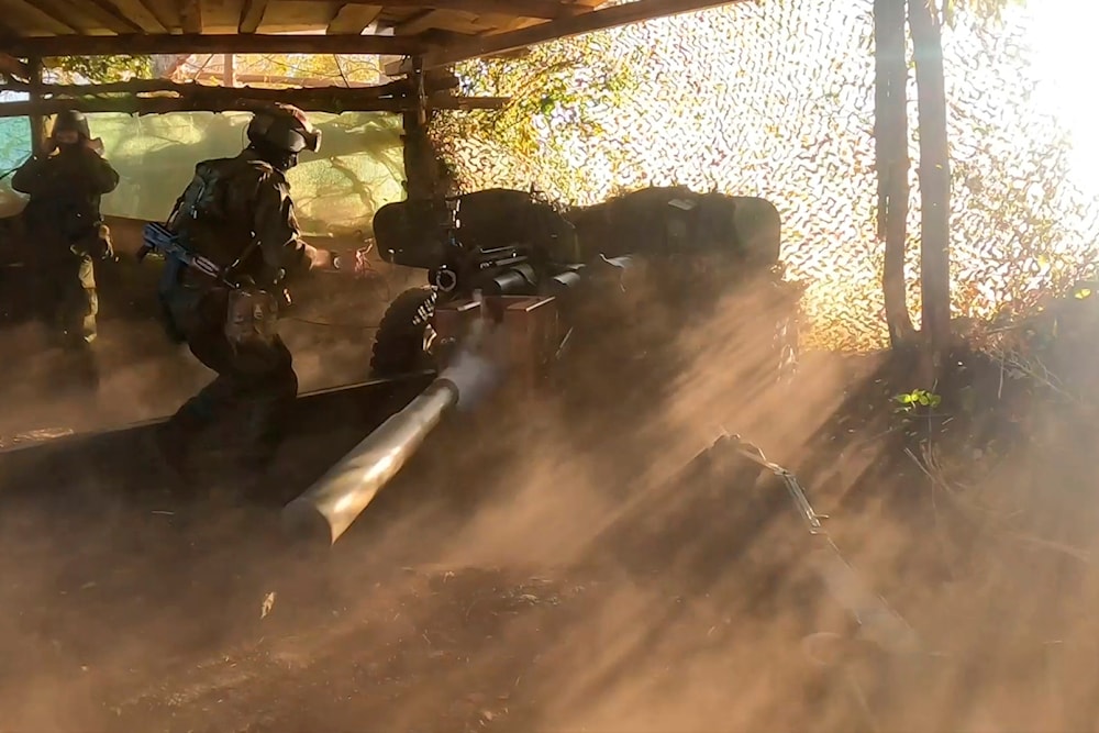 On Friday, Aug. 16, 2024, a Russian soldier fires a Rapira anti-tank gun, in the border area of Kursk region, Russia. (Russian Defense Ministry Press Service via AP)