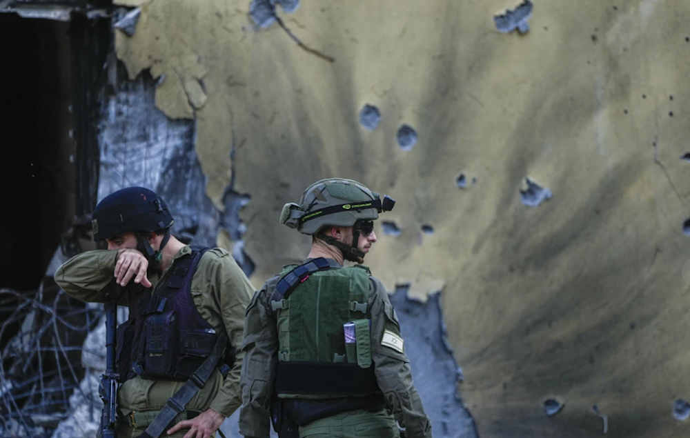 Israeli occupation forces survey the aftermath of Operation al-Aqsa Flood on October 14, 2023. (AP)