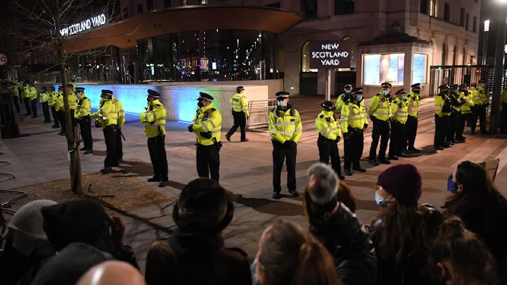 Police officers form a cordon at New Scotland Yard, the headquarters of the Metropolitan Police Service, in central London on March 14, 2021. (AFP)