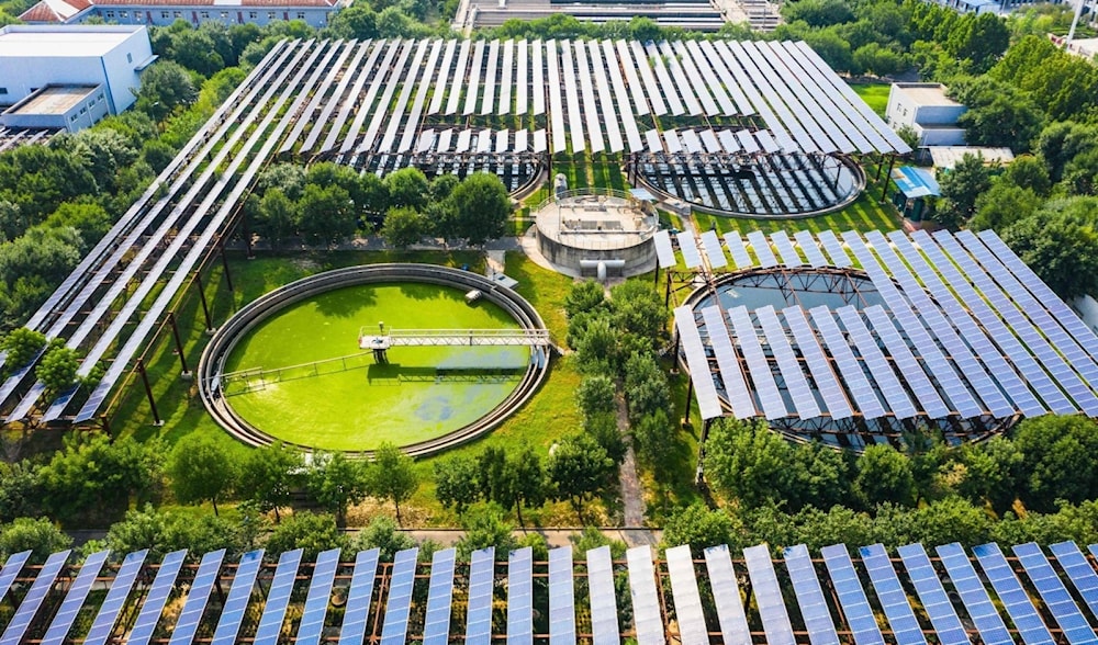 An aerial photo showing solar panels built over a sewage treatment plant in the Henan province, China, on August 4, 2022. (AFP)