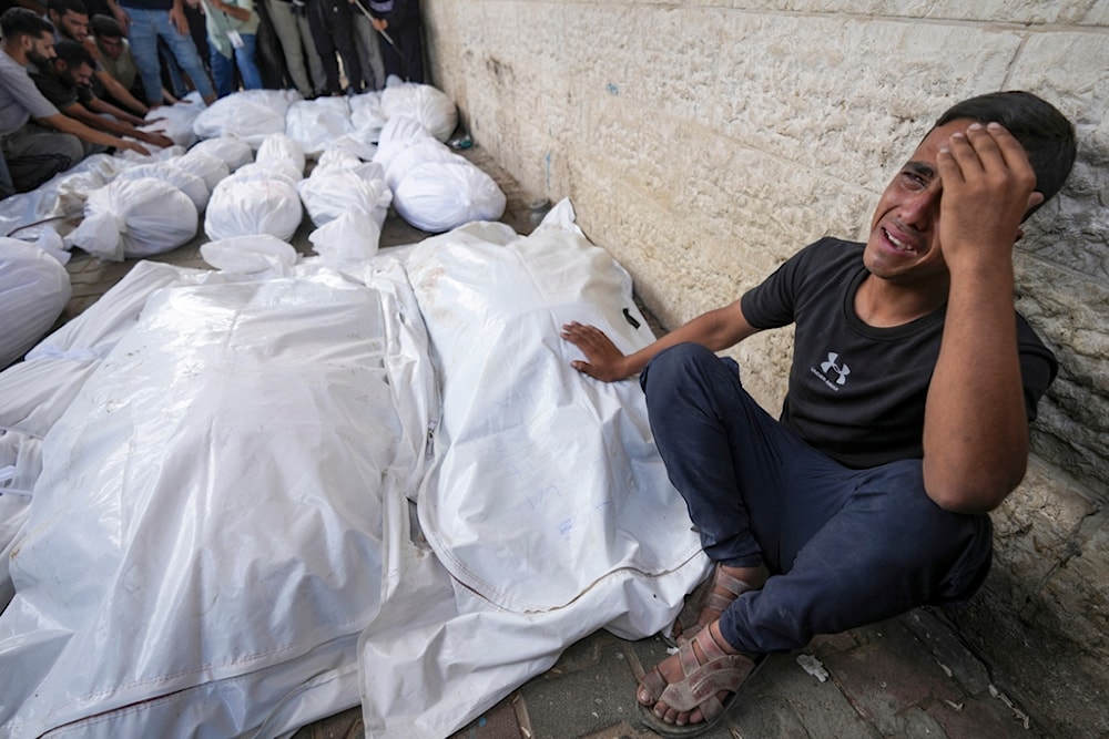 A Palestinian weeps at the funeral for more than 15 people, including children and women, killed in an Israeli strike, at al-Aqsa Martyrs Hospital, Gaza Strip, occupied Palestine, Aug. 17, 2024. (AP)