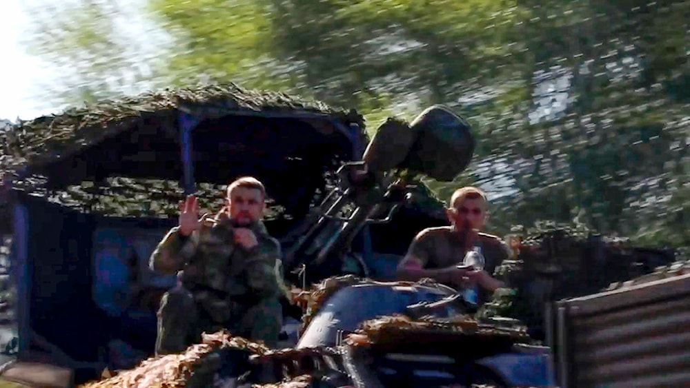 Russian soldiers sit in a military truck as a column of the Russian Armed Forces move to build up forces conducting active combat operations in the Sudzhansky district of Kursk region of Russia. (AP)