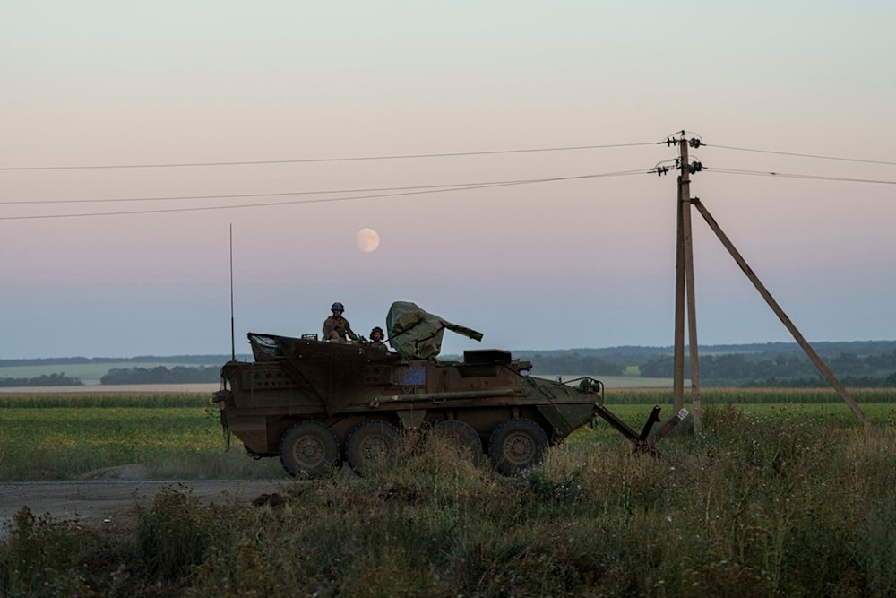 Ukrainian servicemen ride atop on an armored personnel carrier after returning from Russia near the Russian-Ukrainian border in Sumy region, Ukraine, on Saturday, Aug. 17, 2024. (AP)