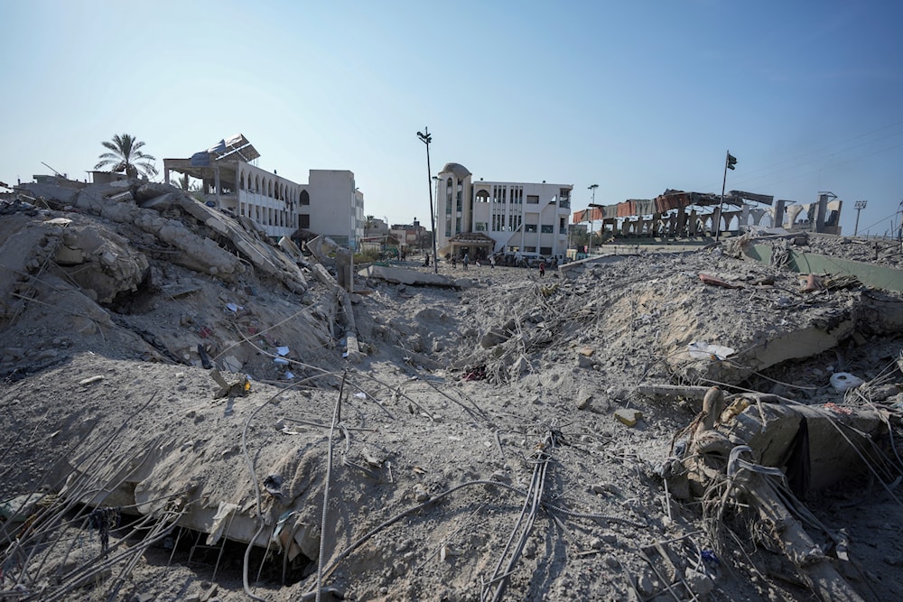 Palestinians inspect the rubble of a school destroyed in an Israeli airstrike on Deir al-Balah, central Gaza Strip, on July 27, 2024. (AP)