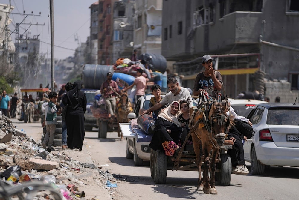 Palestinians evacuate Maghazi refugee camp in the central Gaza Strip, as part of a mass evacuation ordered by the Israeli military ahead of an operation, Saturday, August 17, 2024 (AP)