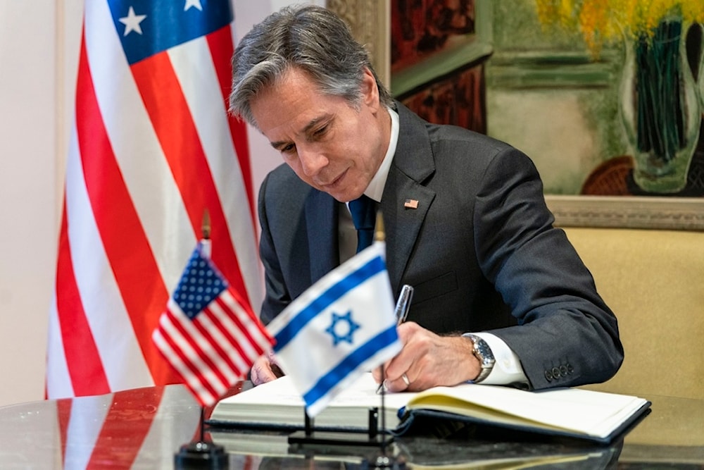 U.S. Secretary of State Antony Blinken signs a guest book before his meeting with Israeli President Isaac Herzog at the Presidency, Sunday, March 27, 2022, in al-Quds. (AP)