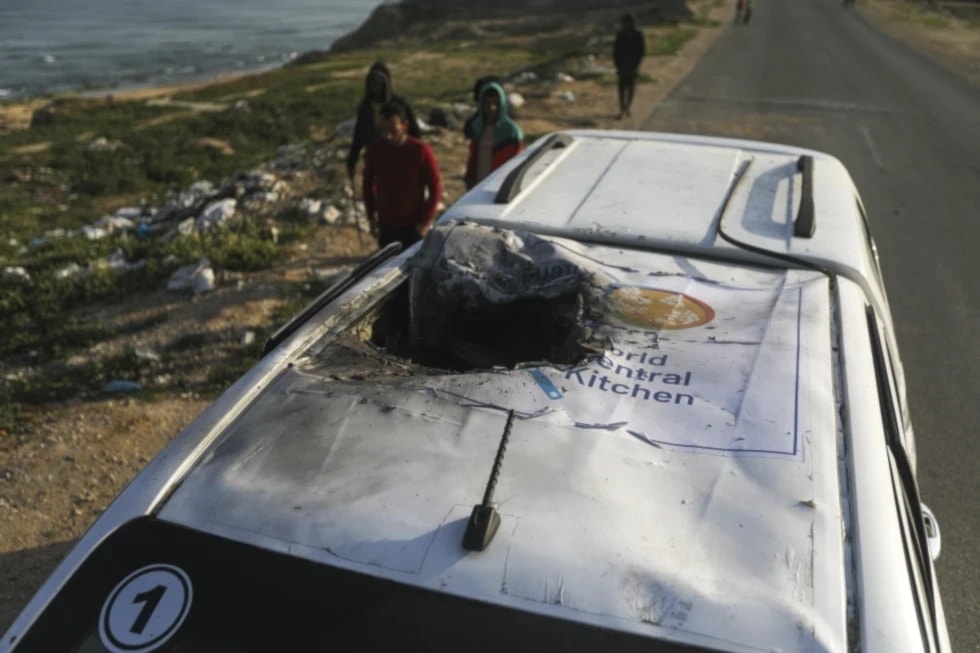 Palestinians inspect a vehicle with the logo of the World Central Kitchen wrecked by an Israeli in Deir al-Balah, Gaza Strip, Tuesday, April 2, 2024. (AP) 