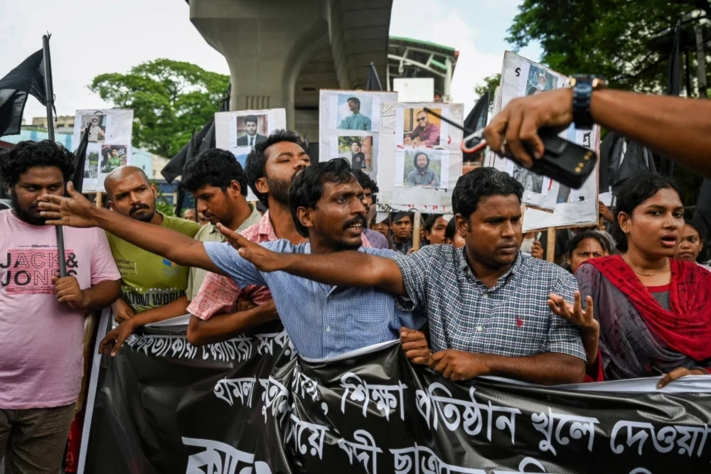 People take part in a protest march against the mass arrests and killings of protesters during violence in Dhaka, Bangladesh. (AFP - Getty Images)