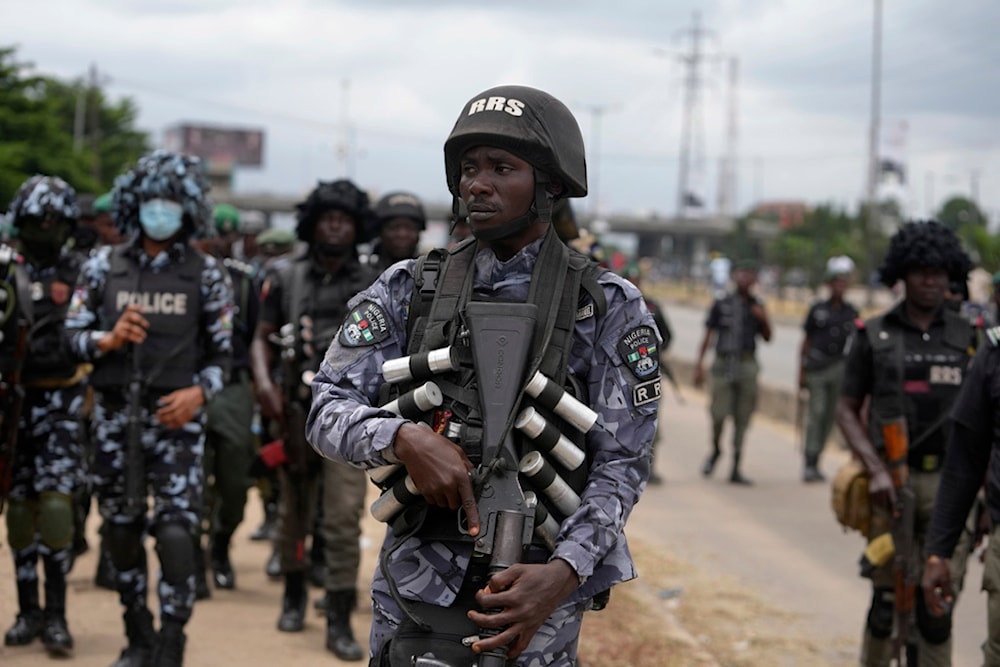 Policemen patrol during a protest against the economic hardship on the street in Lagos, Nigeria, Friday, Aug 2, 2024. (AP)