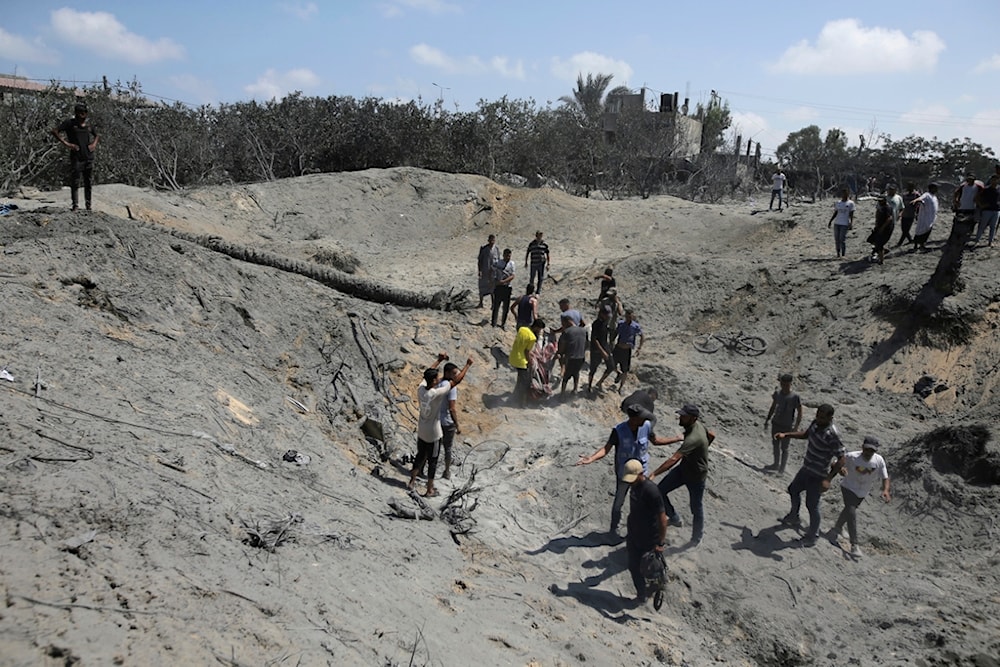 Palestinians search for bodies and survivors in a site hit by an Israeli bombardment on Khan Younis, southern Gaza Strip, Saturday, July 13, 2024. (AP)