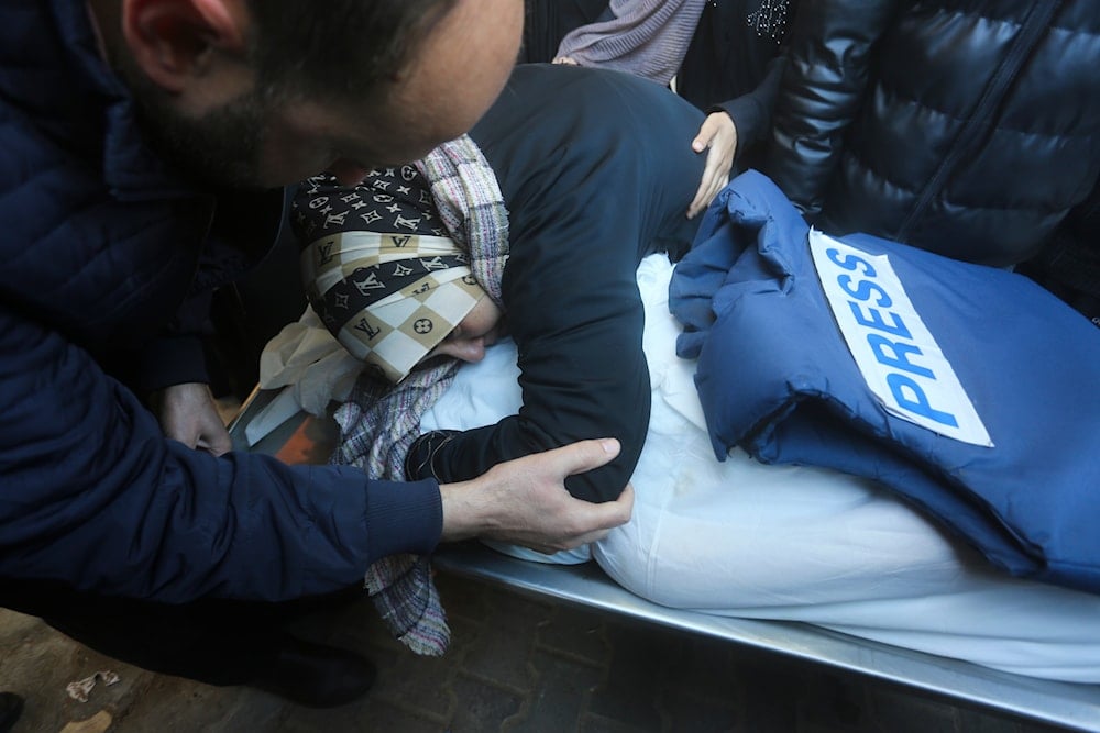 A relative mourns Palestinian journalist Akram al-Shafii, killed in the Israeli bombardment of the Gaza Strip, in a morgue of the European Gaza Hospital in Rafah, January 6, 2024