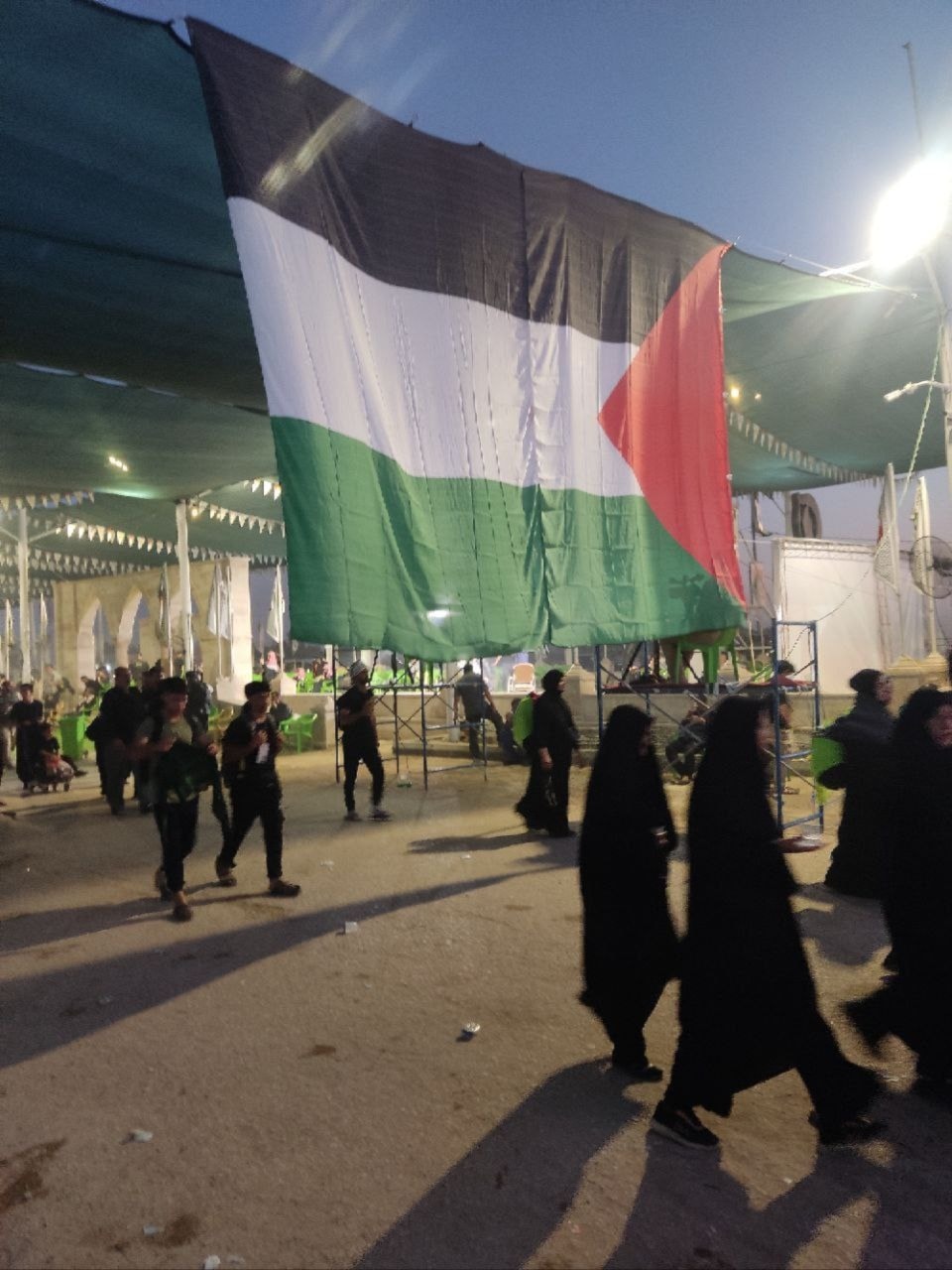 A Palestinian flag hangs over a tent in Iraq's Karbala during the commemoration of the Arbaeen, August 20, 2024 (Social media)