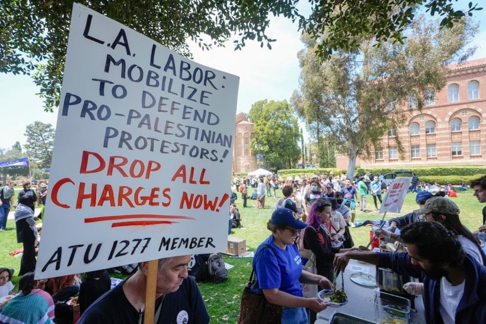 UCLA workers, students, and supporters get lunch after a rally at Royce Quad in the University of California, Los Angeles, UCLA campus Tuesday, May 28,2024. (AP)