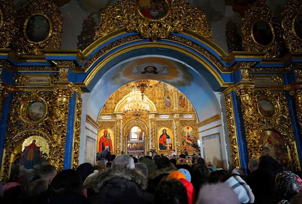 People attend the Christmas service in the Assumption Cathedral in Lavra, the Monastery of the Caves, Kyiv, Ukraine, Saturday, Jan. 7, 2023. (AP)