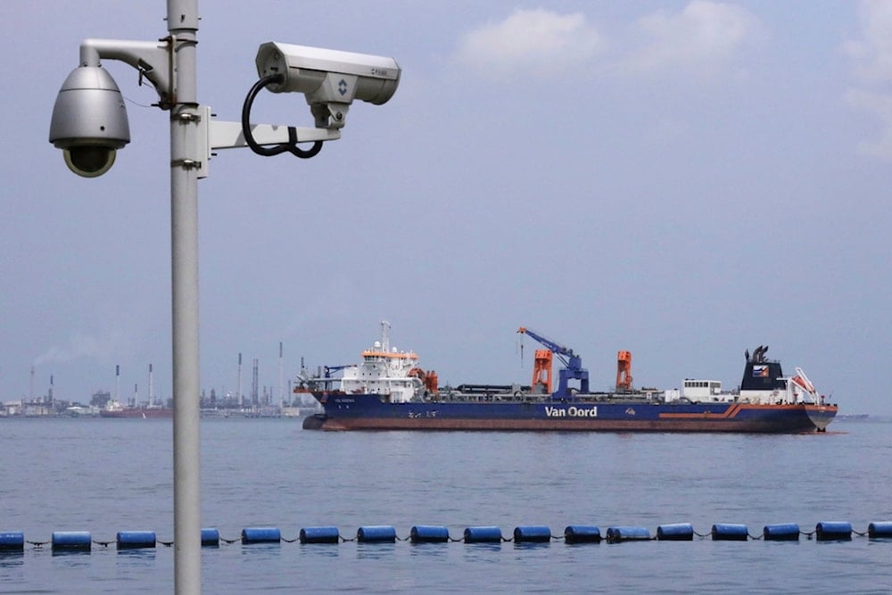 Netherlands-flagged dredger Vox Maxima is seen anchored off the coast in Sentosa Island in Singapore, Sunday, June 16, 2024. (AP)