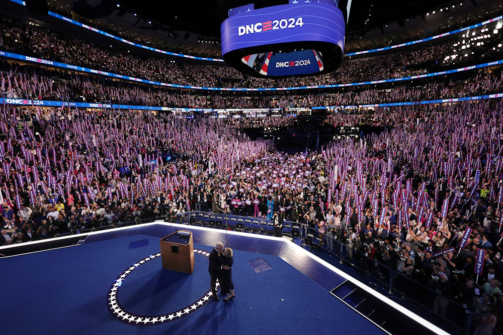 Democratic vice presidential nominee Minnesota Gov. Tim Walz embraces his wife Gwen after speaking on the third day of the Democratic National Convention in Chicago, Aug. 21, 2024. (Pool/AP)