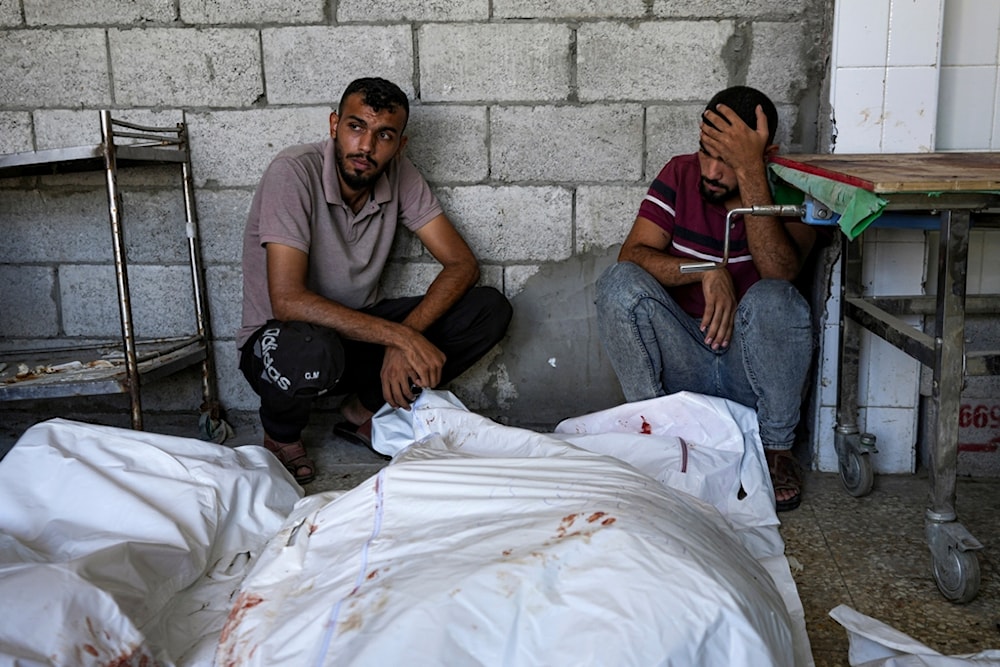 Palestinians mourn relatives killed in the Israeli occupation's bombardment of the Gaza Strip, Palestine, at a hospital in Deir al-Balah, Thursday, Aug. 22, 2024. (AP)