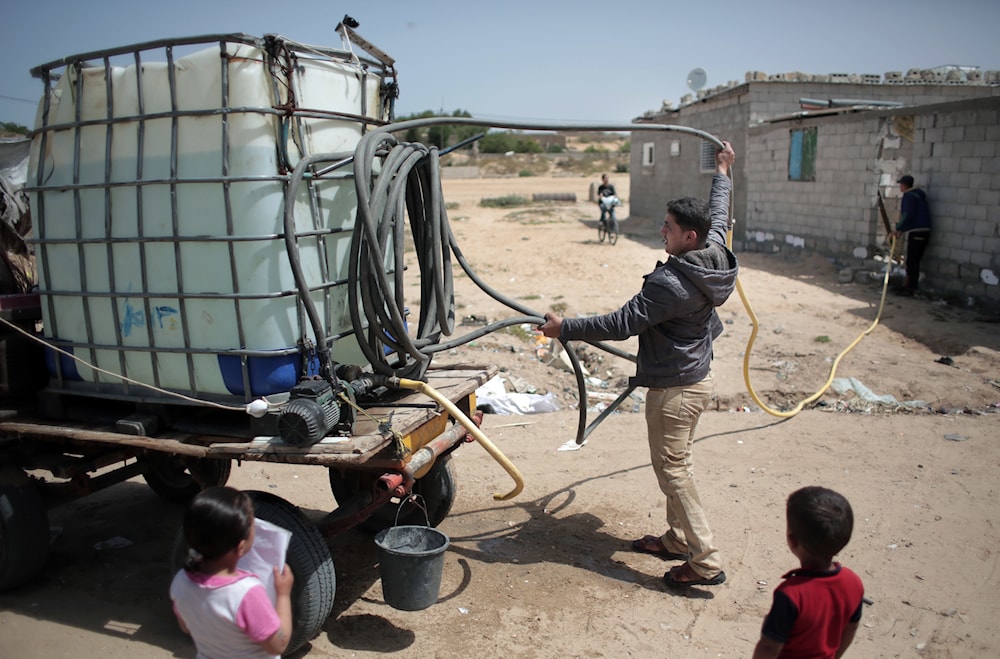 A Palestinian man sells drinking water in Khan Younis refugee camp, southern Gaza Strip on April 16, 2016. (AP)