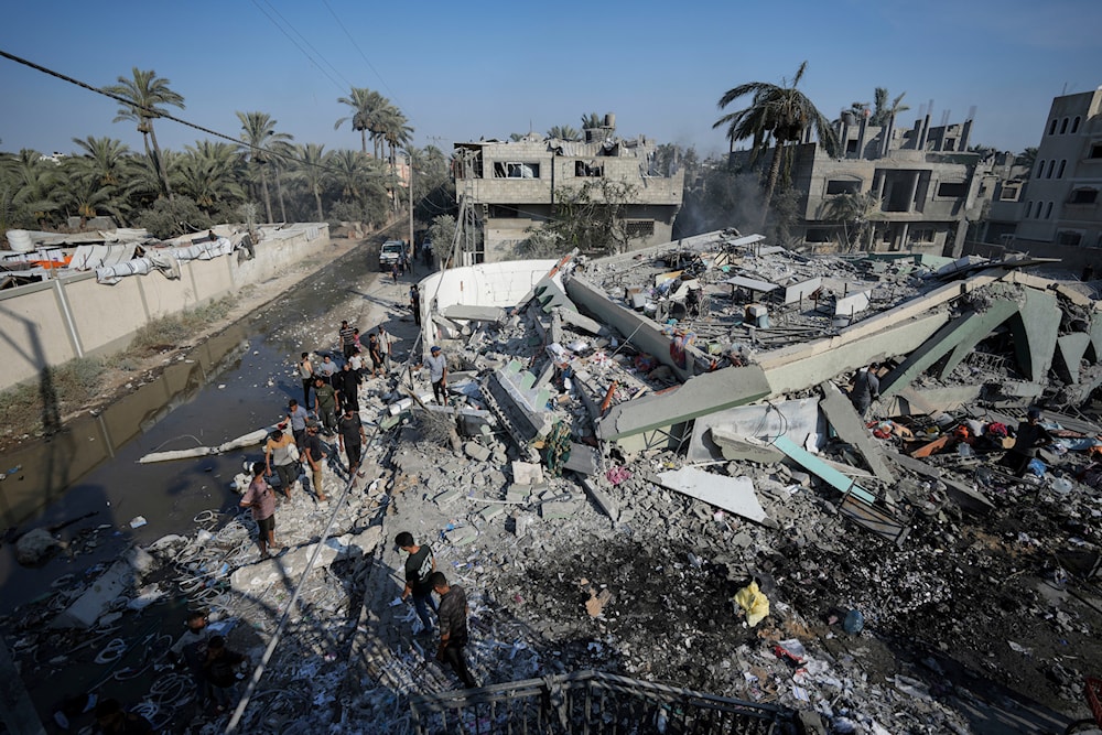 Palestinians inspect the rubble of a school destroyed in an Israeli airstrike on Deir al-Balah, central Gaza Strip, on July 27, 2024. (AP)