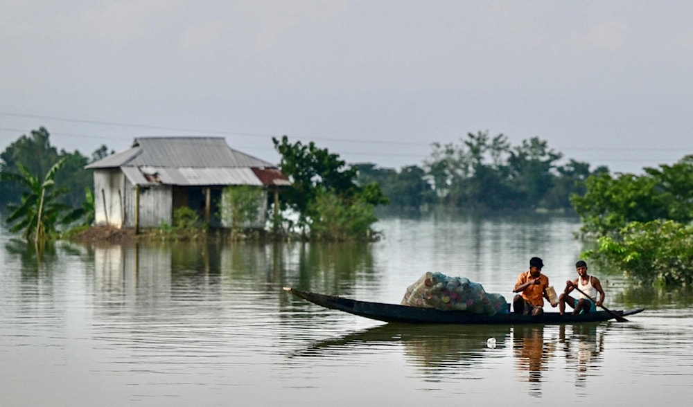 Fishermen at work in a flood-affected area of Sylhet, northeastern Bangladesh, June 21, 2024. (AFP)