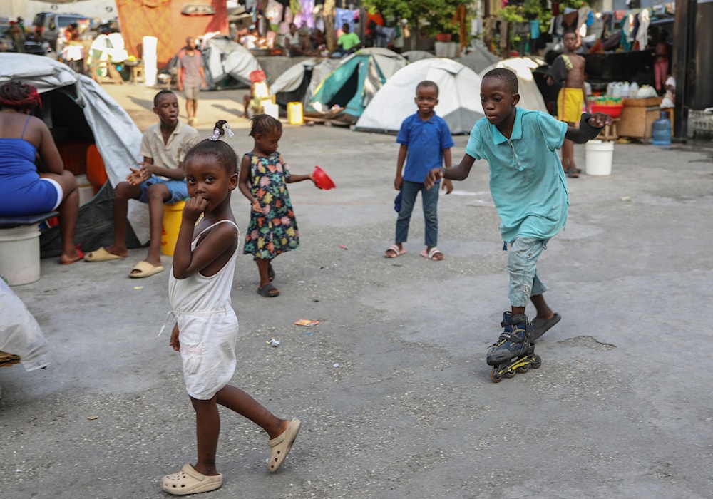 Children play at a gym converted into a makeshift shelter for people displaced by gang violence in Port-au-Prince, Haiti, Thursday, Aug. 15, 2024. (AP)