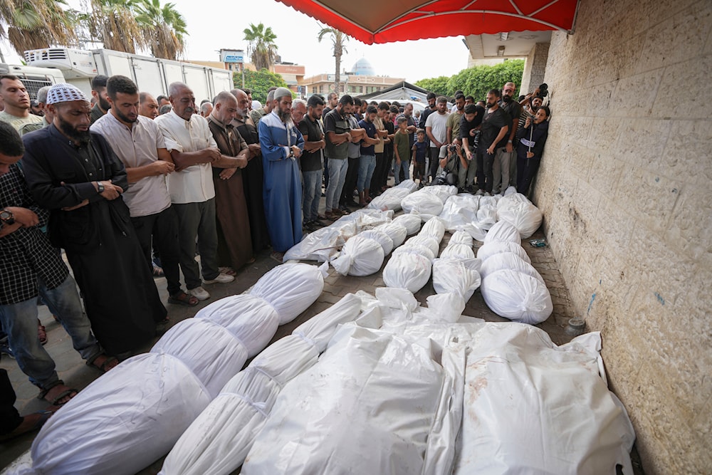 Palestinian mourners pray at the funeral for more than 15 people, including several children and women, killed in an Israeli strike, at Al-Aqsa Martyrs Hospital in Deir al-Balah, Gaza Strip, Aug. 17, 2024. (AP)