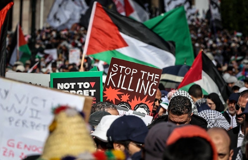 Protesters lift placards and flags of Palestine during a demonstration in Rabat on February 11, 2024. (AFP)