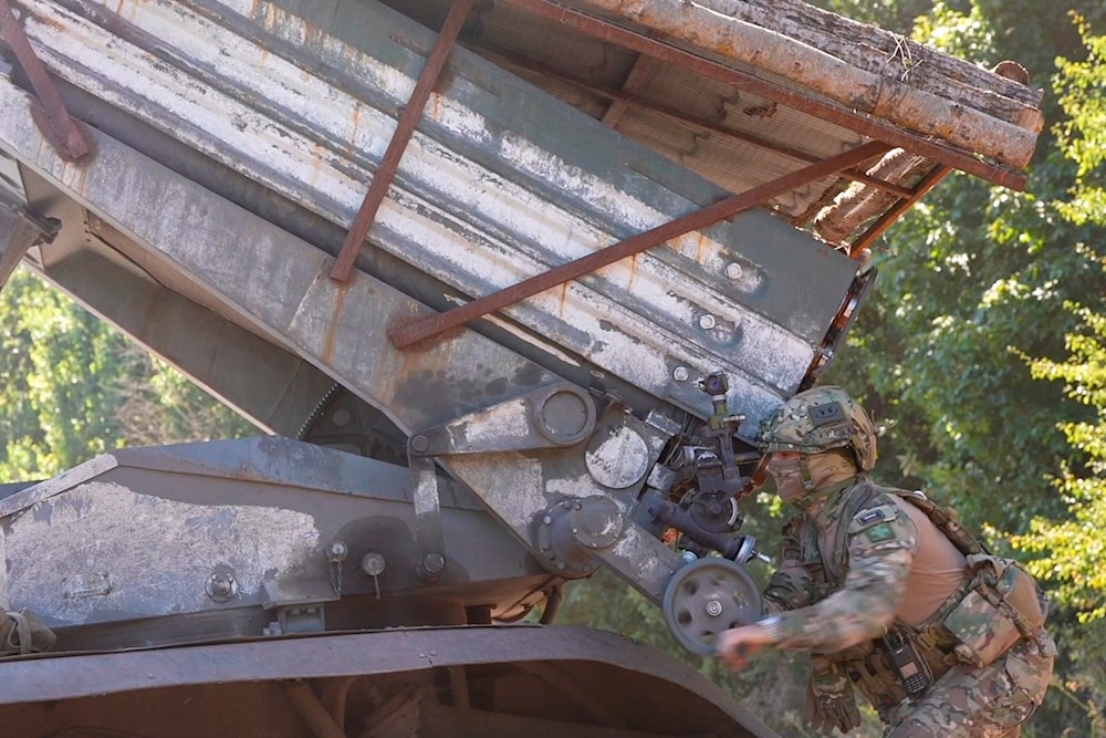 In this photo taken from video released by Russian Defense Ministry press service on Thursday, Aug. 22, 2024, Russian serviceman aims a Grad self-propelled 122 mm multiple rocket launcher in Kursk region, Russia. (Russian Defense Ministry via AP)