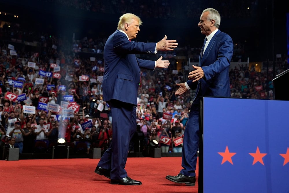 Republican presidential nominee former President Donald Trump embraces Independent presidential candidate Robert F. Kennedy Jr. after getting his endorsement at a campaign rally, Friday, August 23, 2024, in Glendale, Arizona (AP)