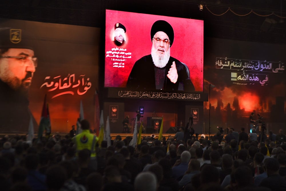 Hezbollah leader Sayyed Hassan Nasrallah speaks to his supporters through a screen, during a ceremony to commemorate the death of top commander Fouad Shukur, who was killed by an Israeli airstrike last week, in Beirut, Lebanon, Tuesday, Aug. 6, 2024. (AP)